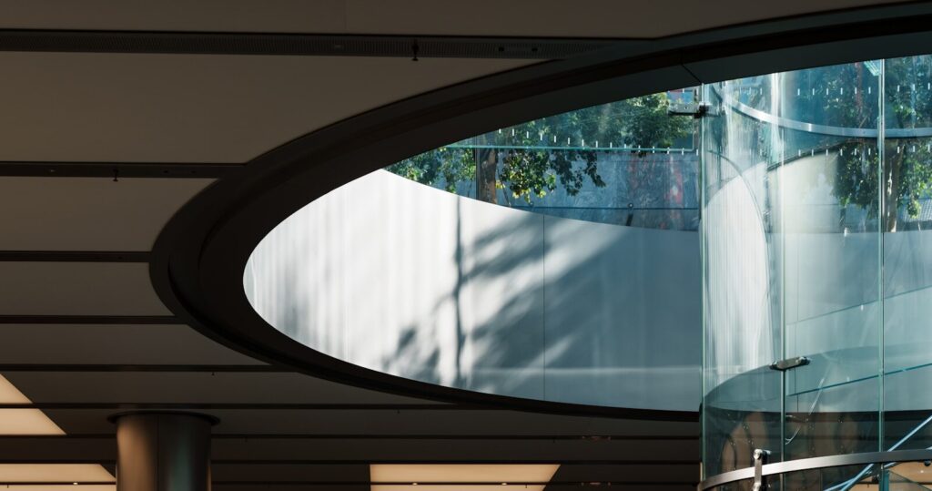 Modern glass spiral staircase with natural light